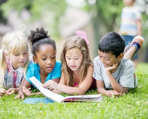 Kids reading in the park