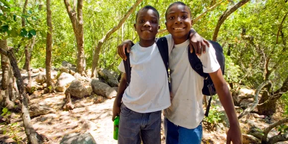 Two boys in wooded park